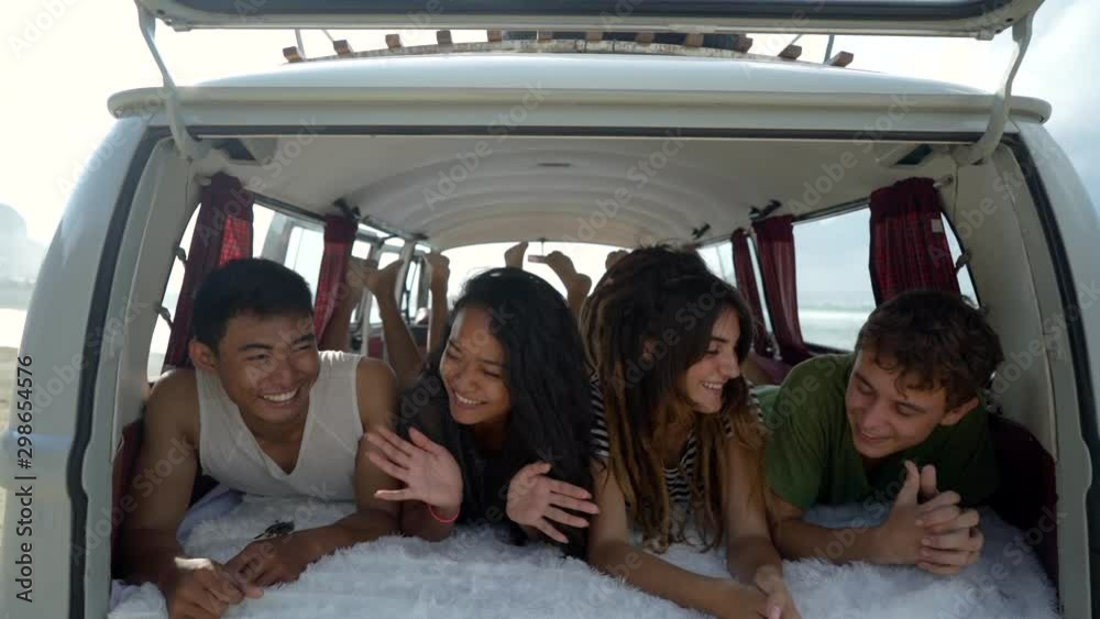 young people enjoy holiday lay down relax inside vintage van on sunny day young people enjoy holiday lay down relax inside vintage van on sunny day