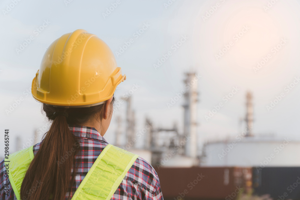 Concept of team, engage, construction, professional, safety and industry.construction worker or engineer with yellow helmet safety going work Industrial zone,The equipment of oil refining in morning Concept of team, engage, construction, professional, safety and industry.construction worker or engineer with yellow helmet safety going work Industrial zone,The equipment of oil refining in morning