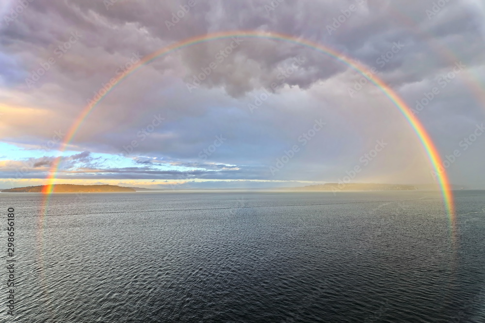 Colorful views of the rainbow against the sky, clouds and sea horizon. Commencement Bay,Tacoma,USA      A. - obrazy, fototapety, plakaty 