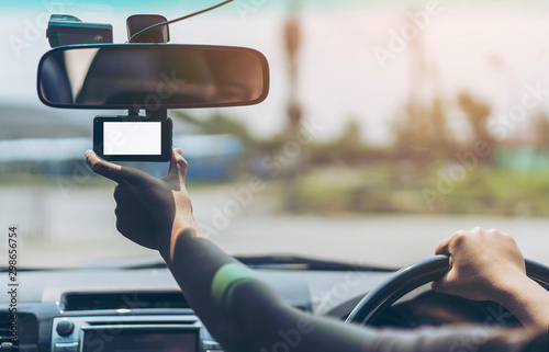 Hand driver or Technician sit on driver seat set up front Car Camera. Blank Screen of car camera mock up while road accident or driving recording real time.People,driving, safety,CCTV car concept