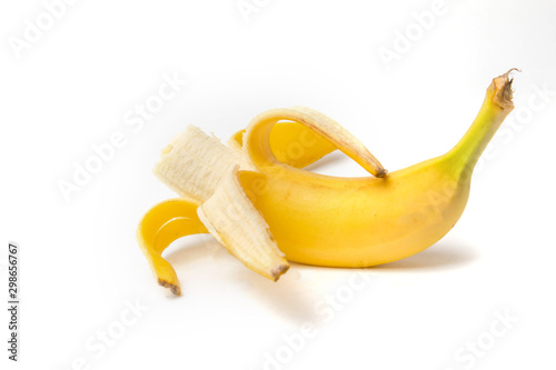 ripe yellow banana half peeled and bitten on a white background isolate