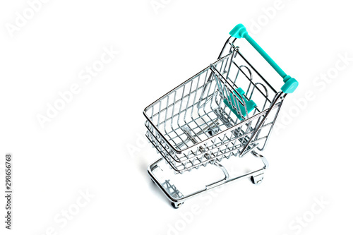 Miniature empty shopping cart turquoise color on white background. isolated. Top view, flat lay.