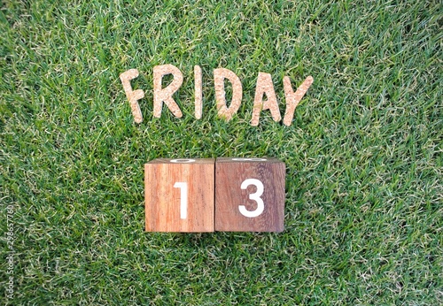 Friday 13th on green grass. bad luck, Misfortune Day, Halloween Concept.