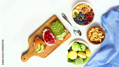 breakfast top view isolate white background. oatmeal with berries, toasts on a wooden tray, nuts, coffee