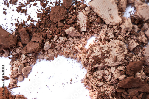 Macro texture Broken eye shadow brown powder, isolated on white background