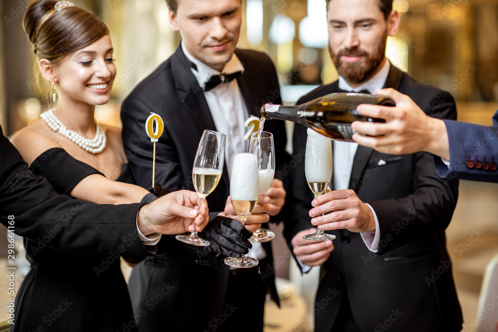 Well-dressed people celebrating New Year indoors