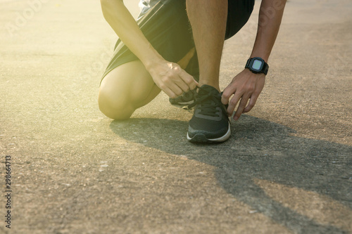 Runner tying shoelaces;concept of running
