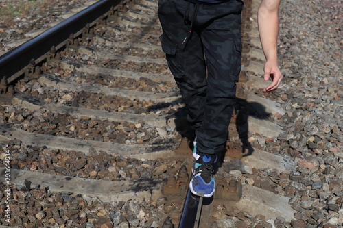 woman walking on railroad tracks