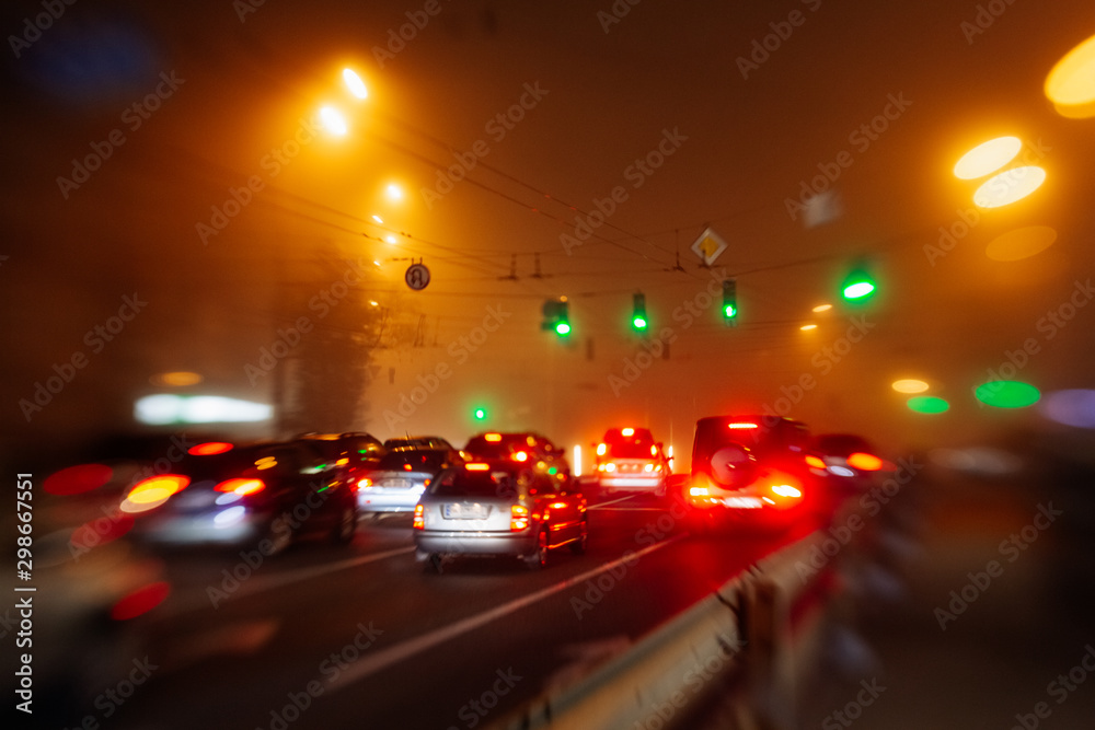 Busy traffic in city fog blur lights of cars on road