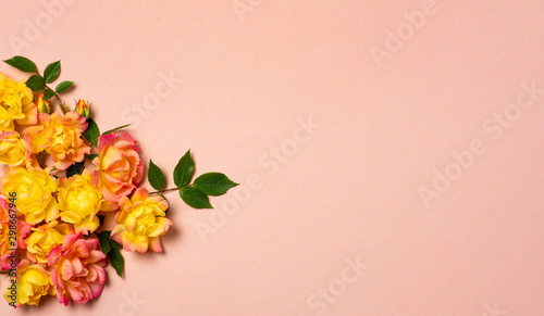 Yellow and orange roses arrangement on pastel background