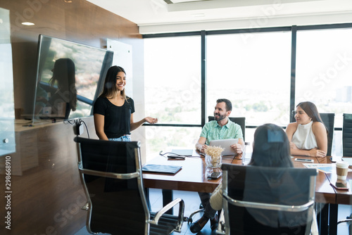 Businesswoman Positively Explaining New Project In Meet At Office