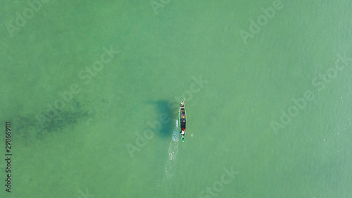 Aerial view the fisherman drive the boat to put the fishing nets in the sea where the water is very clear