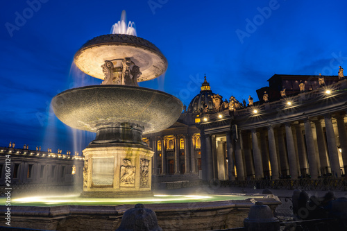 Night picture of Maderno's fountain and St. Peter's Basilica at the background during blue hour. Long exposure photo of Maderno's fountain in Vatican City.