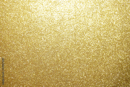 gold Sparkling Lights Festive background with texture. Abstract Christmas twinkled bright bokeh defocused and Falling stars. Winter Card or invitation	
