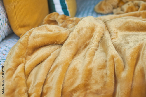 closeup of beige blanket on bed on decoration store photo