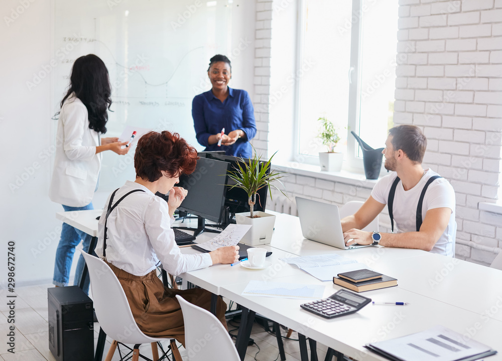 Multi ethnic people meet in white office to discuss business deal, developing Multi ethnic people meet in white office to discuss business deal, developing