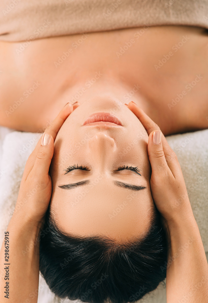 Woman enjoying head massage, face close-up. Relaxing anti-stress massage, treatment head pain