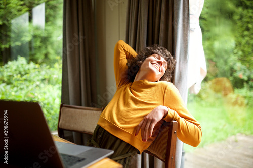 woman relaxing at home looking out of window photo