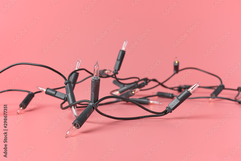 Christmas lights garland on a pink background. Christmas lights garland on a pink background.