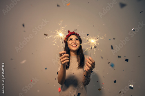 Asian woman fun holding sparklers. Young girl celebrating Christmas or New Year eve party at night. Happy new year