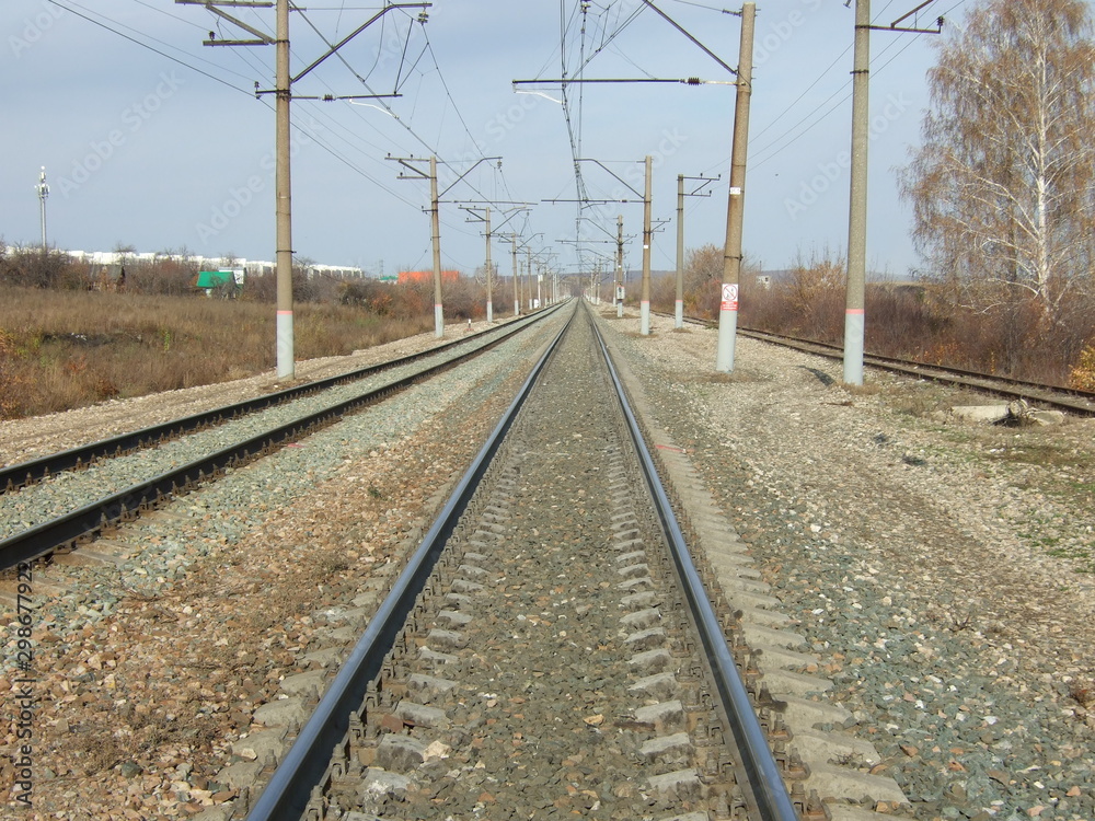 Railway. Bright sunny day. The rails go into the distance.