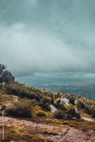 View of the countryside nature landscape on a moody dark hiking travel with fog, mist and clouds in the mountains. Serra de Monchique, Algarve in Portugal