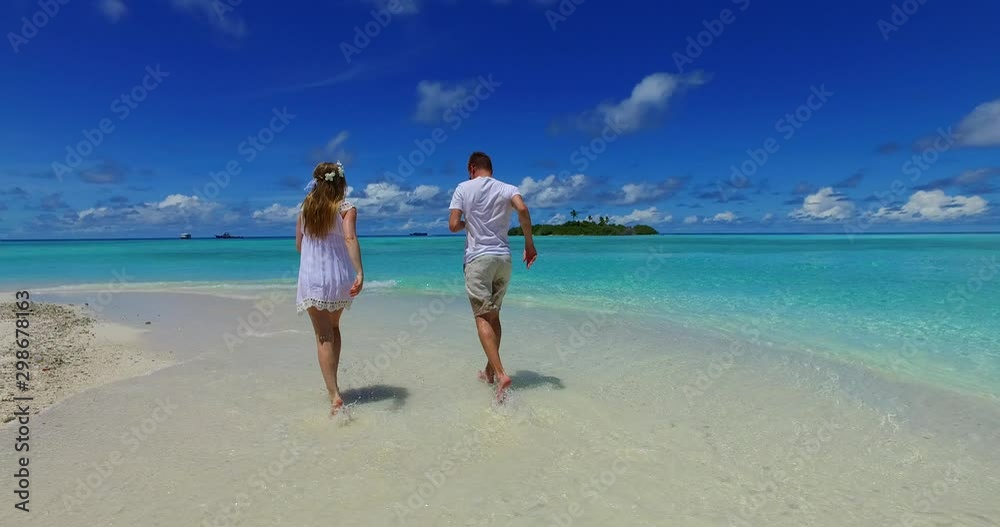 Young couple running and enjoying on the tropical beach Young couple running and enjoying on the tropical beach