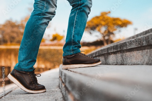 Image of a man walking up the stairs.