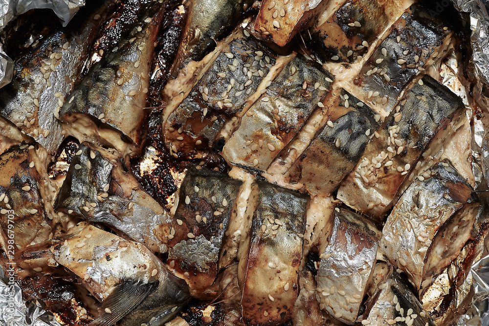 Baked slices of fish mackerel sprinkled with sesame seeds.