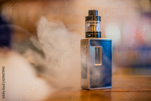 Electronic cigarette on a background of vape shop. E-cigarette for vaping.