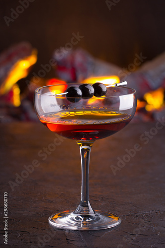 Manhattan cocktail on fireplace background