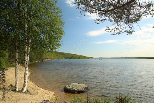 Sand beach at lake Vargforsdammen, a reservoir in the stream Skelleftealven in Northern Sweden photo