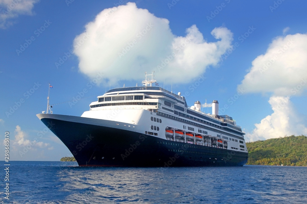 World voyage cruise ship at anchor off the beautiful tropical island of Bora Bora, French Polynesia.