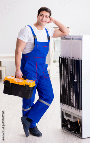 Repairman contractor repairing fridge in DIY concept