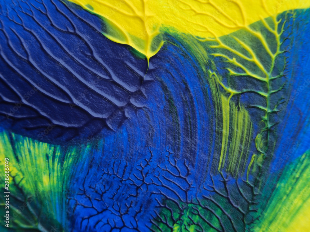 Obraz premium The acrylic painting with blue, green and yellow color texture on white paper background by using rorschach inkblot method.
