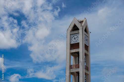 Clock tower with blue sky and white clouds.