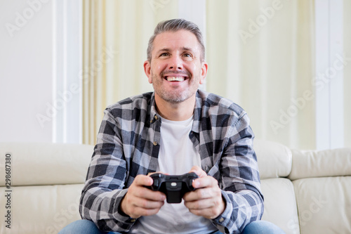 Caucasian man playing video games at home