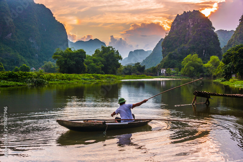 Fisherman on boat in Trang An  near Ninh Binh  Vietnam