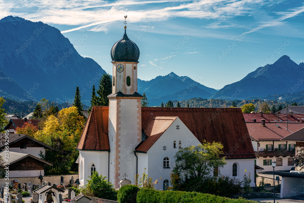 St. Jakob church in the bavarian village Wallgau with the alps in the background