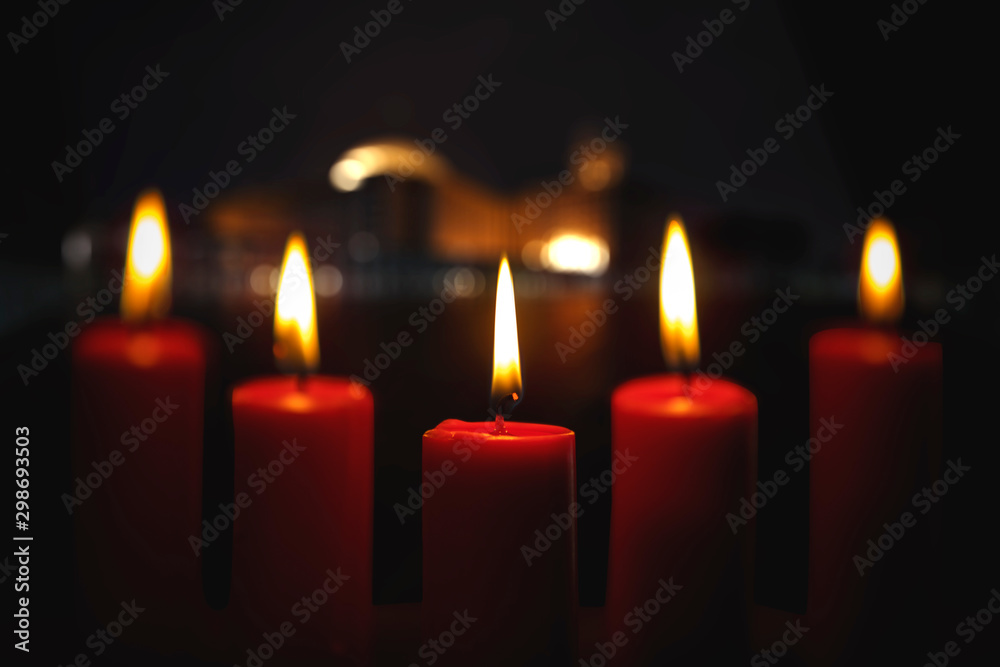 Five red Christmas candles with blurred lights Five red Christmas candles with blurred lights