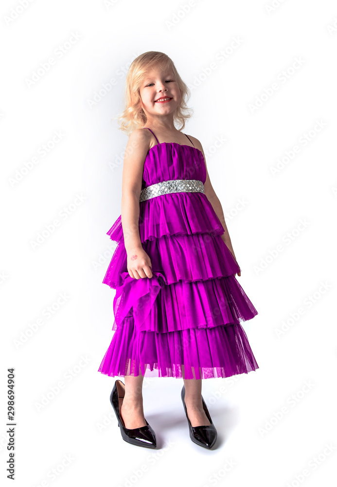 little princess blonde in pink retro dress and mother's shoes on a light background.