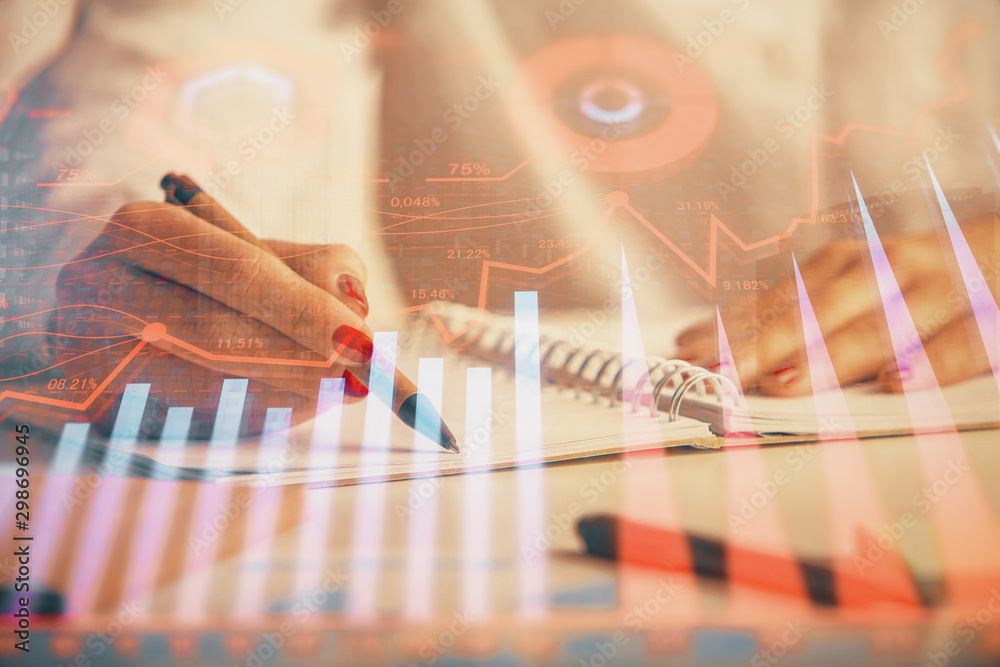 Double exposure of woman's hands making notes with forex graph hologram. Concept technical analysis. Double exposure of woman's hands making notes with forex graph hologram. Concept technical analysis.