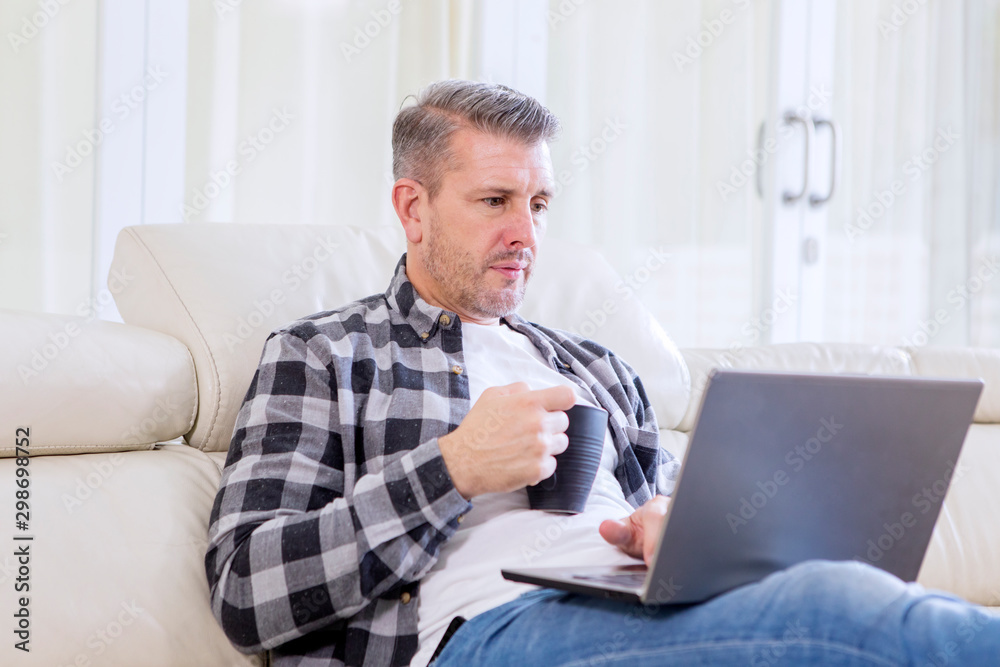 Man enjoying leisure time with coffee and laptop