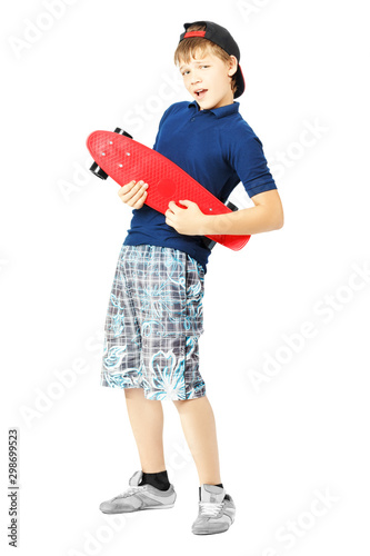 Teenage boy gesturing with a skateboard, as if playing the guitar, isolated on a white background. photo