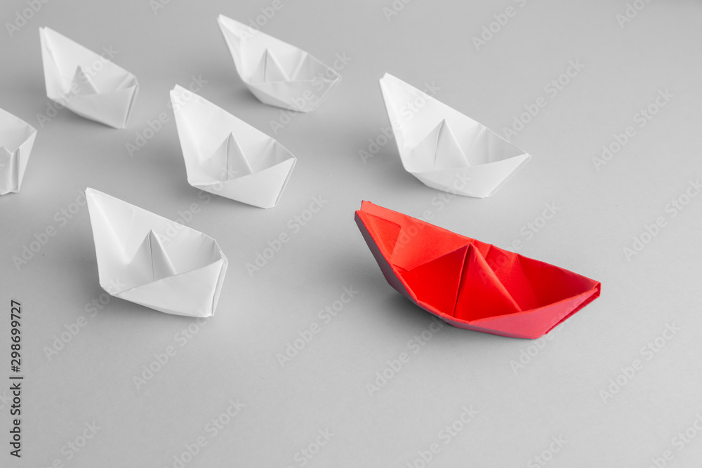 Leadership concept using red paper ship among white. From above. text space Leadership concept using red paper ship among white. From above. text space