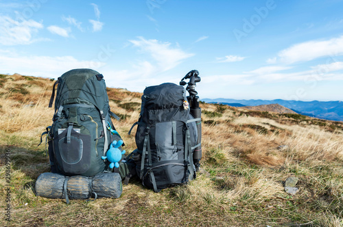 Two hiking backpacks. Travel backpacks on a background of mountains.