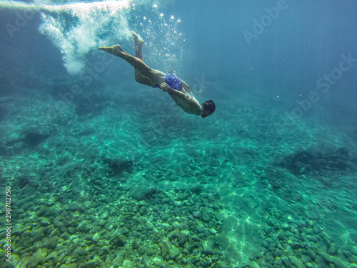 man dives into the depths of the sea without fins. freediving