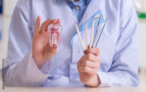 Dentist practicing work on tooth model photo