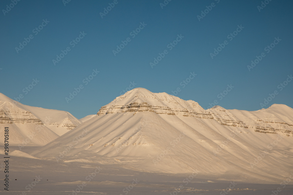 Beautiful arctic winter landscape with snow covered mountains on Svalbard, Norway