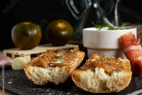 Pan tumaca, desayuno español. Pan con tomate, jamón y ajo. photo